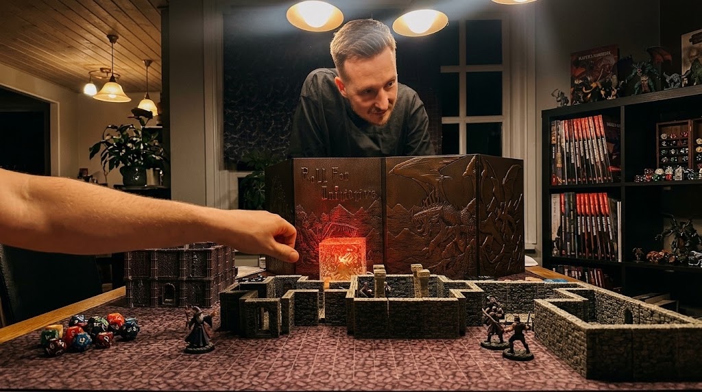 Nikita behind a screen at his own table, a dungeon laid out in front of the players